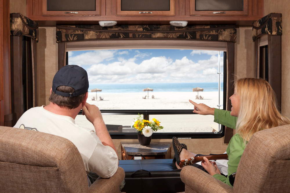 Couple Enjoying Beach View while sitting in their RV furniture