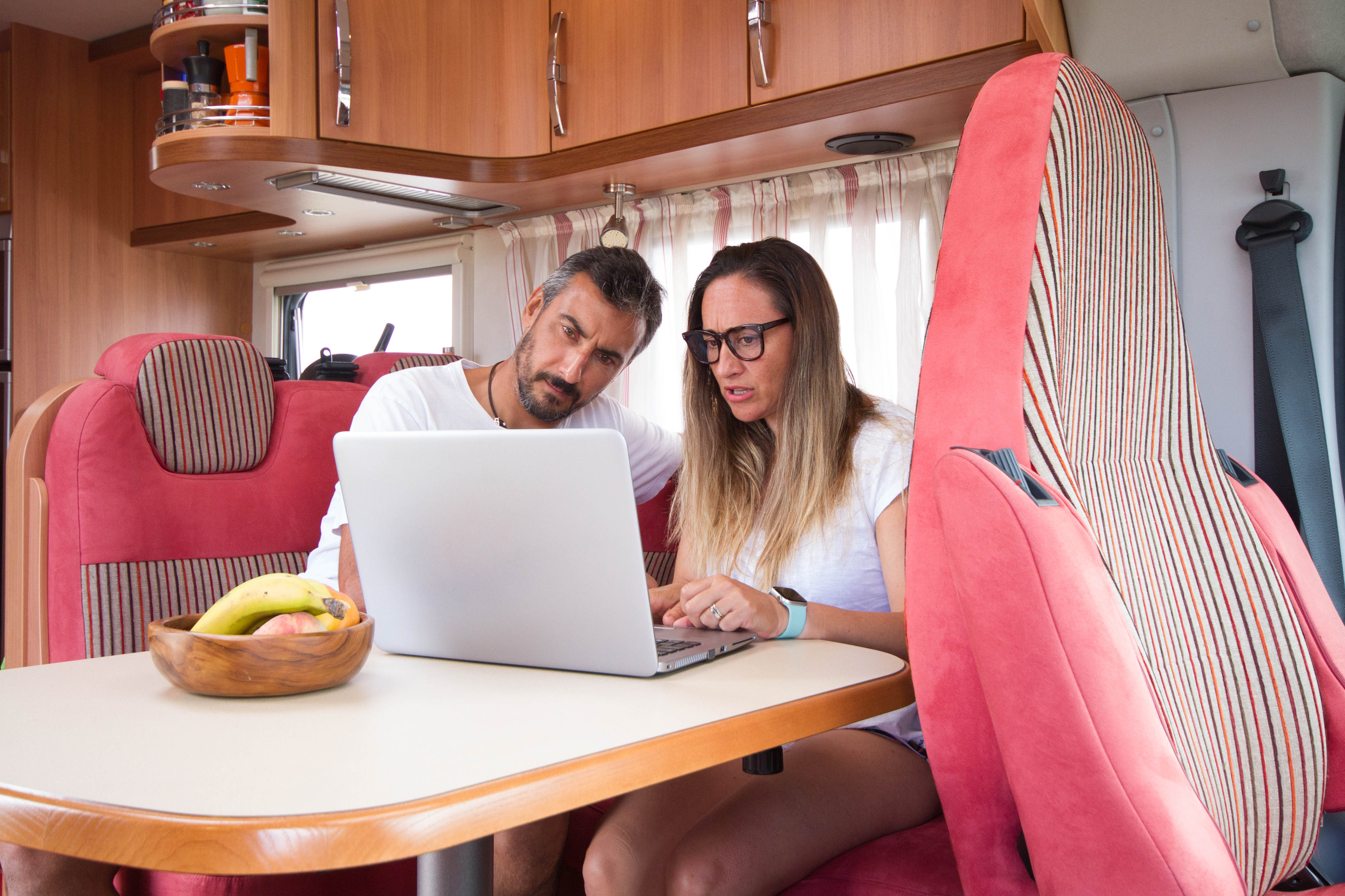 setting up your motorhome office - man and woman working on laptop in RV