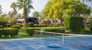 luxury RV resorts - tennis court with Class A parked behind 