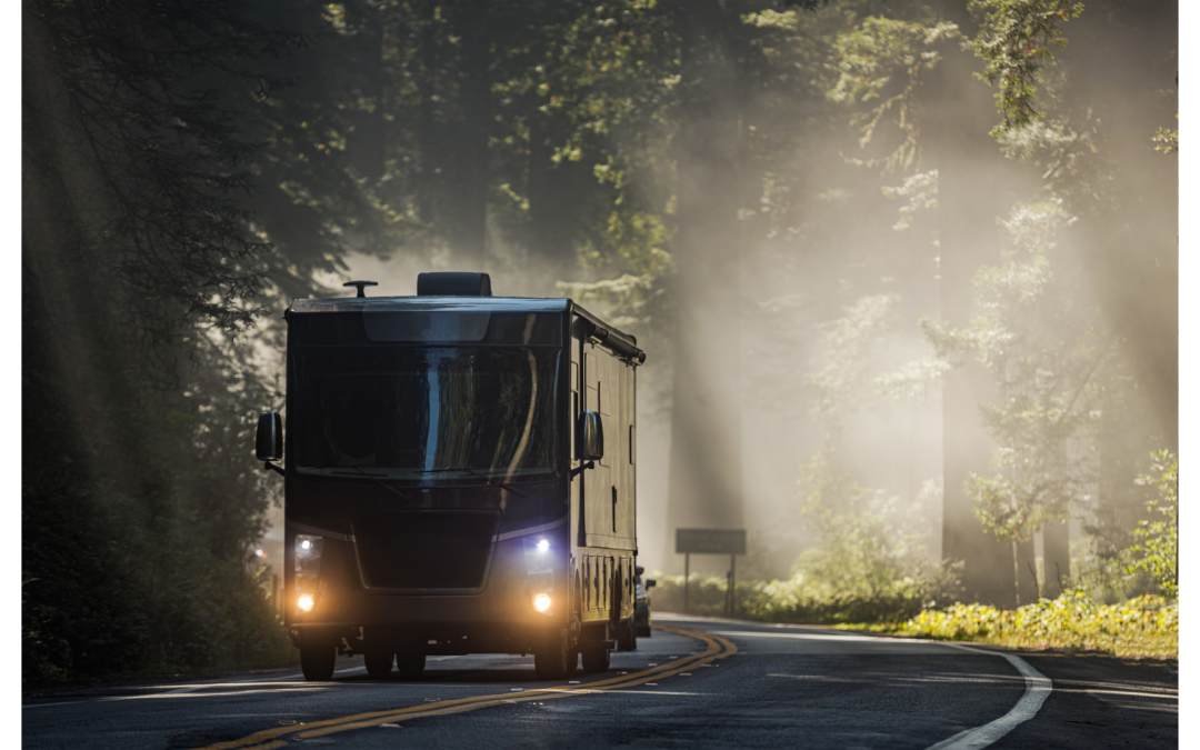 A new 2022 Class A motorhome driving in the woods.