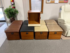 Ottomans for closeout sale stacked in the showroom.