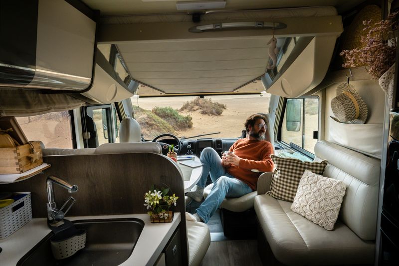 Man comfortably leans back on an RV recliner.