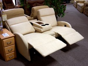 Custom RV seating by Lambright. A cream colored theater seating set in the showroom at Bradd and Hall. 
