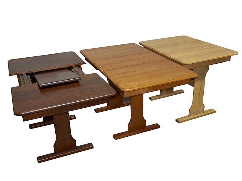Three expandable RV tables in different stain colors. 