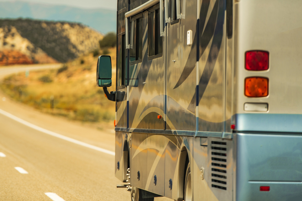 Class A Diesel Pusher RV Motor Coach on a scenic highway.