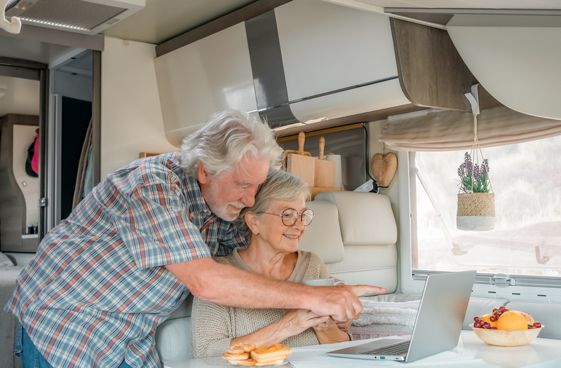 Couple shops top RV furniture brands on their laptop.