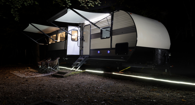 A trailer lit up at night with outdoor lighting. 