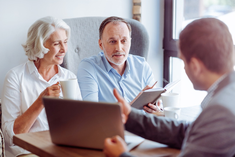 A couple meets with an insurance agent to discuss their RV coverage. 