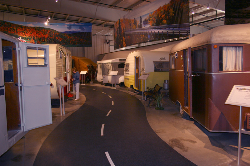 Inside of the RV and motorhome museum. Shows old RVs on a road. 