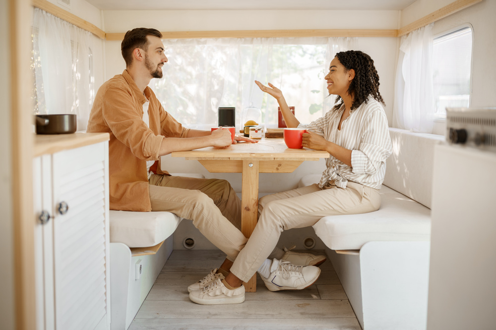 Couple having breakfast in an RV. 