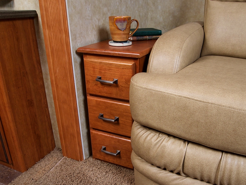 A Bradd and Hall cubby cabinet installed in a motorhome with a mug of coffee set on top. 