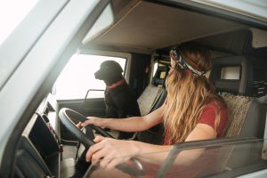 woman with dog inside a van