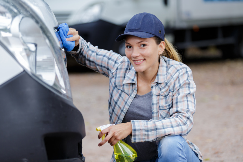 Woman cleaning the outside of an rv 