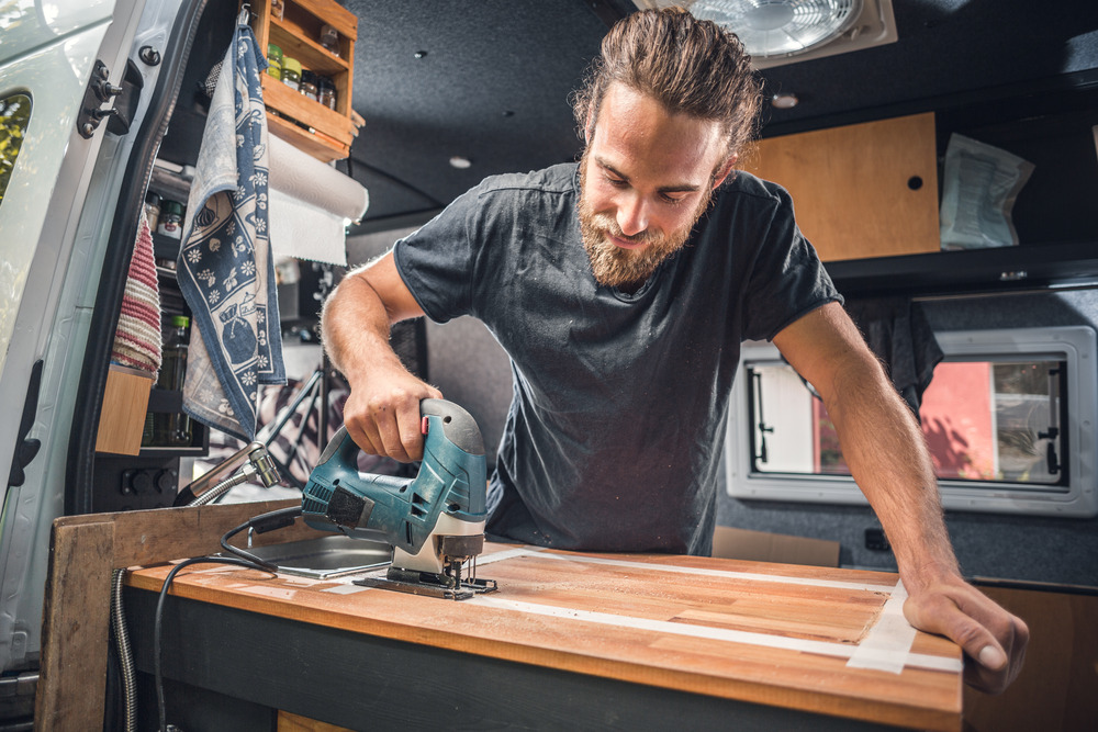 man remodeling the countertop in a  motorhome 